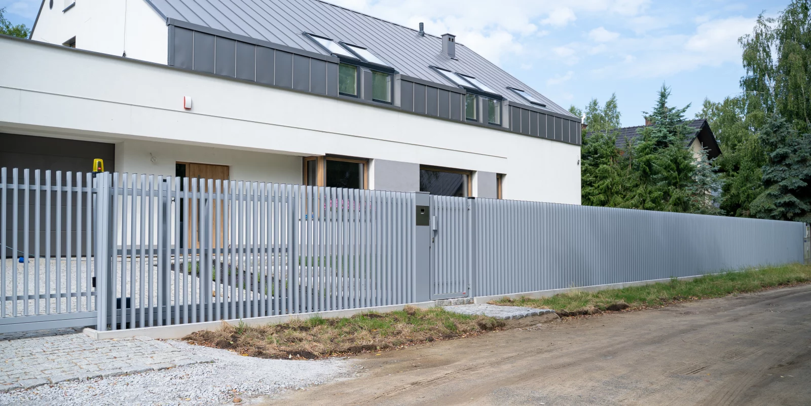 Vrijdragende schuifpoort met bijpassend hekwerk in lichtgrijs